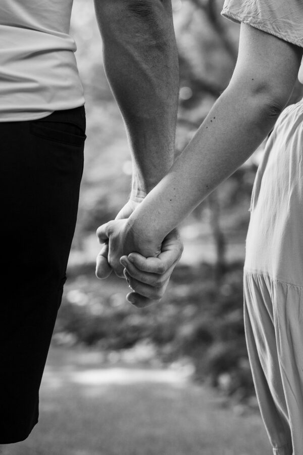 Joshua and Hailey holding hands outdoors
